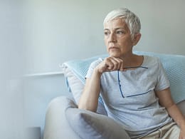 senior woman worried holding eyeglasses gettyimages .jpg