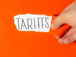 tariffs on torn orange paper.jpg
