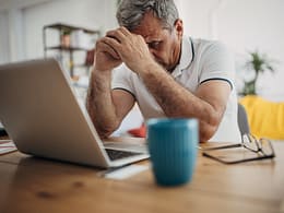 older man laptop upset.jpg