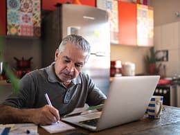 senior man laptop taking notes gettyimages .jpg