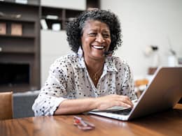 smiling person sitting in front of laptop.jpg