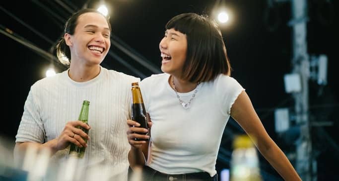 man and woman drinking beer on rooftop FlmiMS.width .jpg