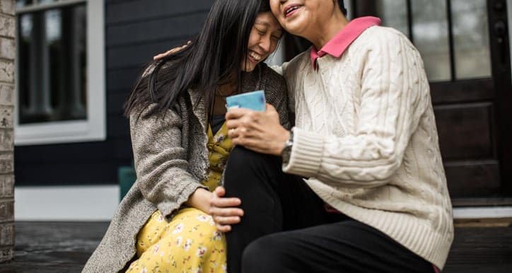 adult woman and senior mom seated hugging Syn.width .jpg