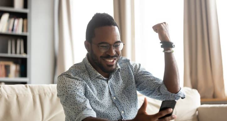 happy man with phone pumping fist dWwY.width