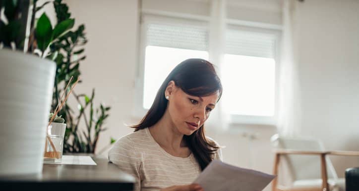 worried woman reading letter.width .jpg