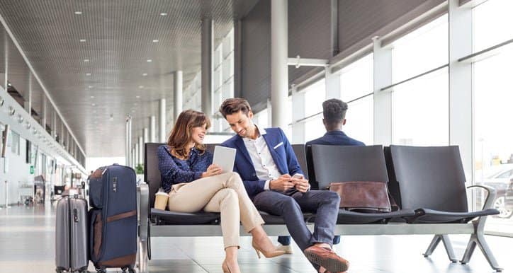 man and woman sitting at airport opGWJ.width .jpg