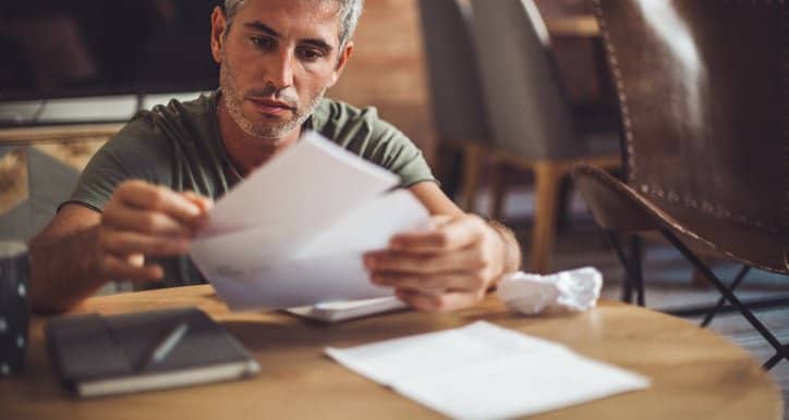 man with bills at desk fggd.width .jpg