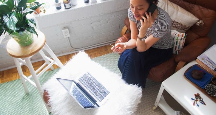 woman on phone with credit card and laptop y.width .jpg