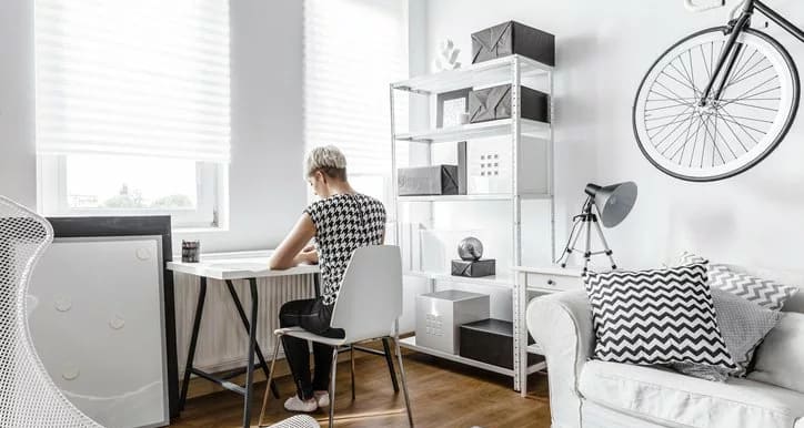 young woman at desk in small apartment.width .jpg