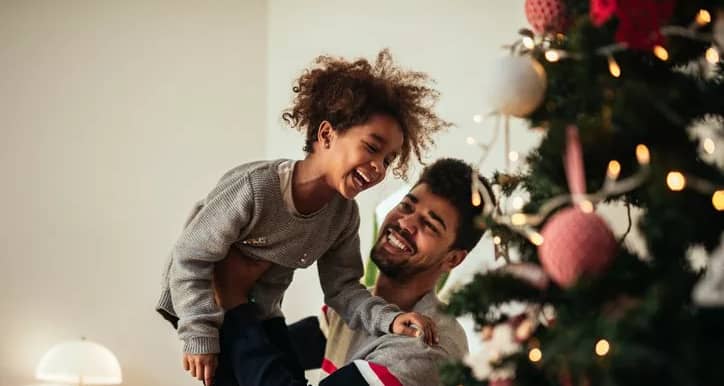 dad and daughter decorating christmas tree.width .jpg