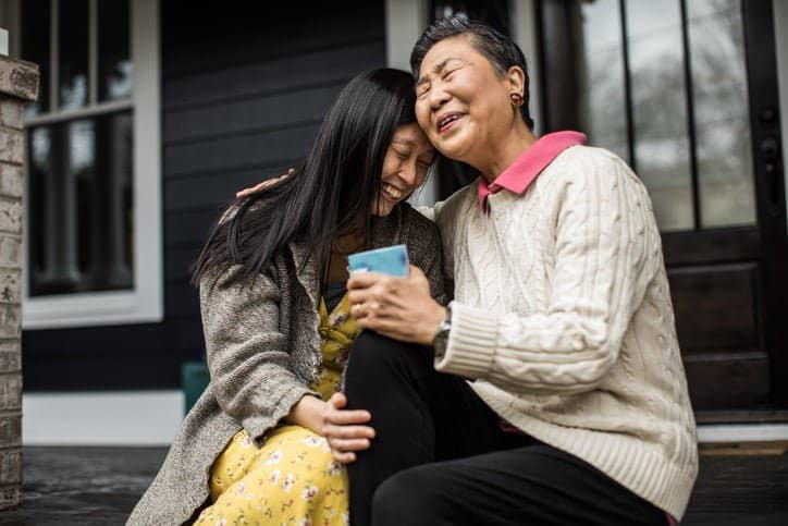 adult woman and senior mom seated hugging Syn.width .jpg