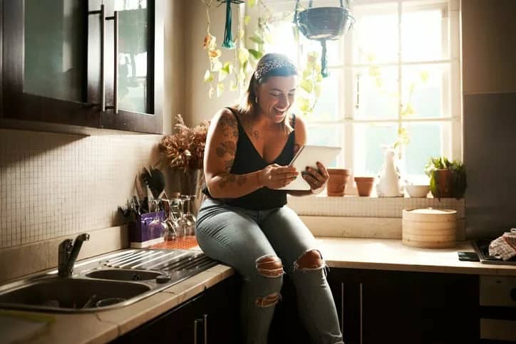 woman on kitchen counter in apartment zhAoe.width .jpg