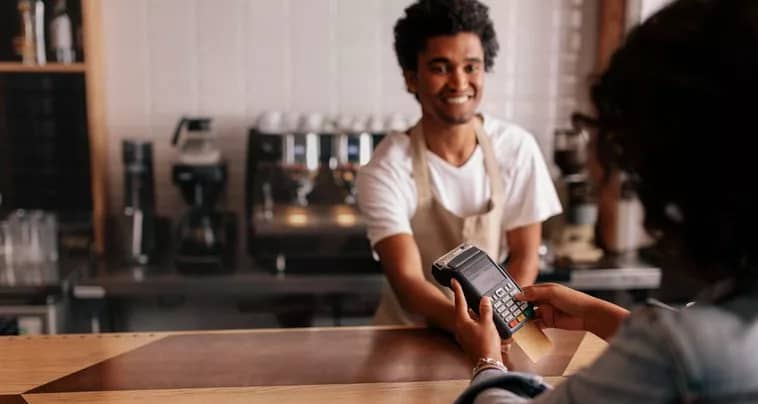 woman paying cafe cashier with credit card.width .jpg