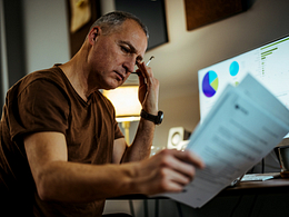 middle aged man serious looking at documents gettyimages