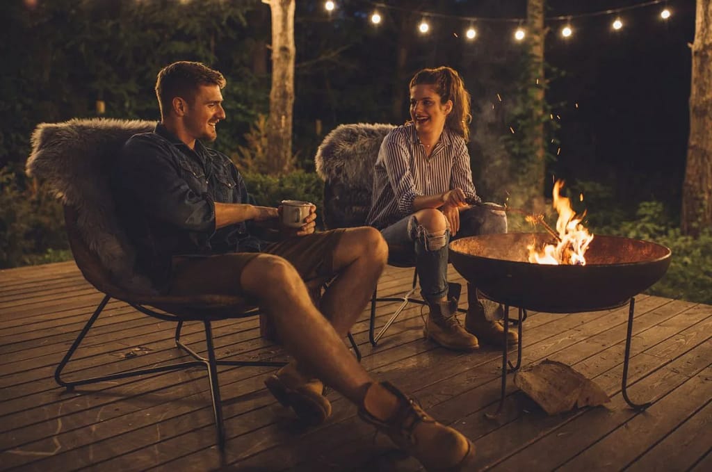 Young couple relaxing by a campfire PXmvo.width .jpg