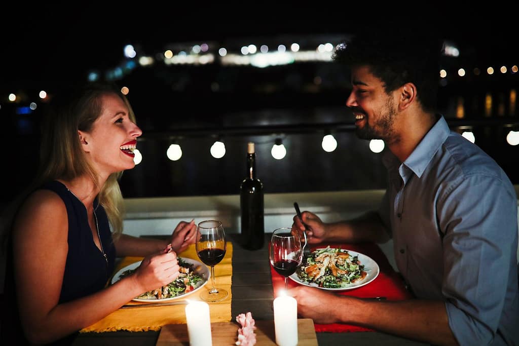 young man and woman sitting at table eating d.width YXBhB.jpg