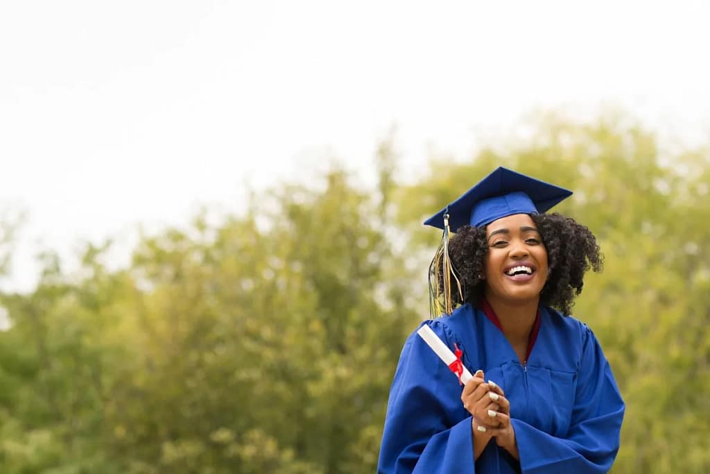 young smiling woman on graduation day wearing.width TjRKa.jpg