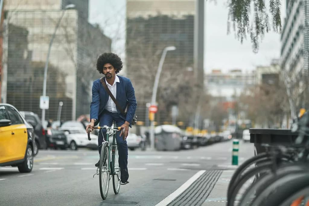 person riding bike on city street kTdlO.width .jpg