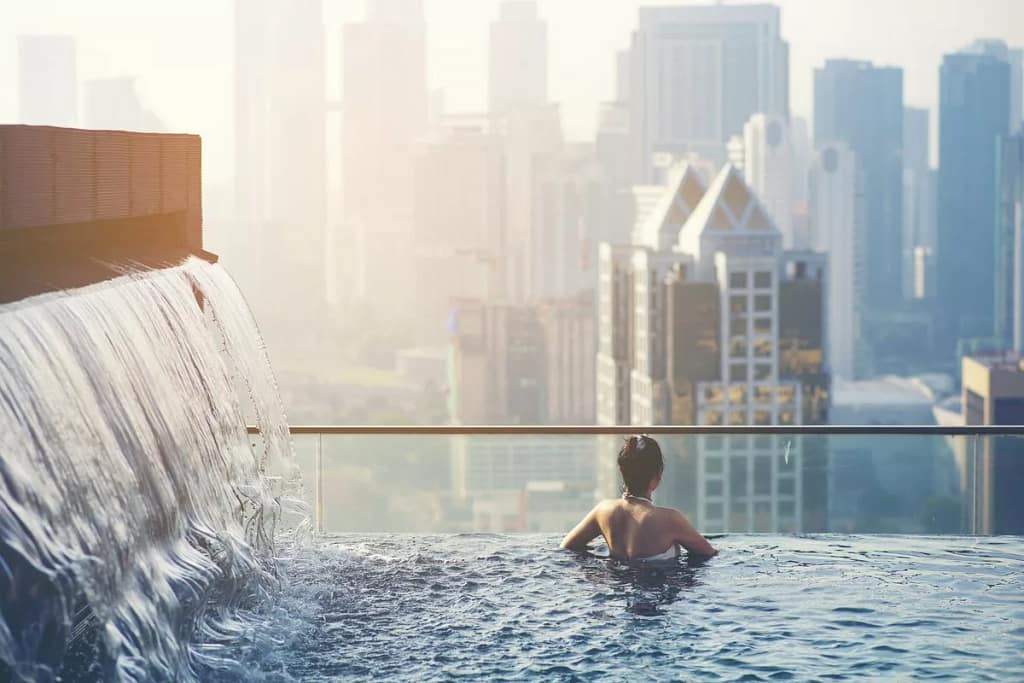 Woman in rooftop pool over city EEPugl.width .jpg