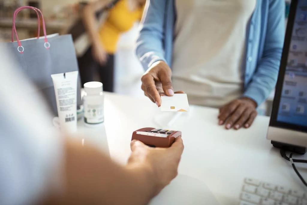 woman paying with credit card at pharmacy tKE.width .jpg