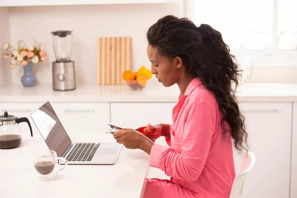 Woman sitting in front of her laptop cutting .width GXFCLY.jpg