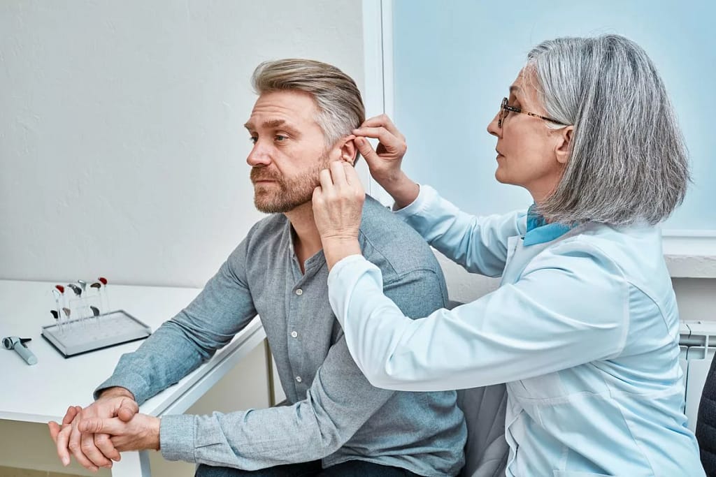 Mature person being fitted for hearing aids. .width .jpg