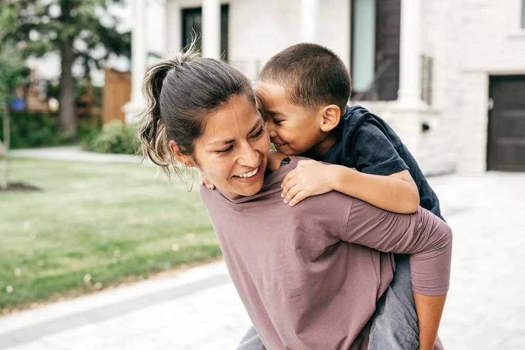 mom giving son piggyback kpUvdY.width .jpg