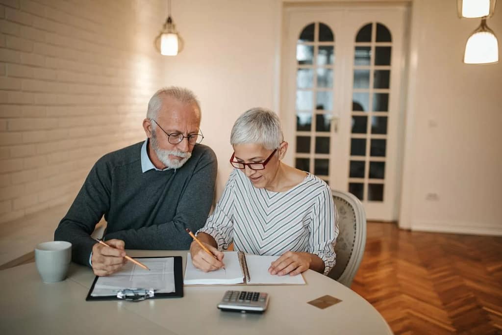 elderly couple with notebook and calculator r.width .jpg