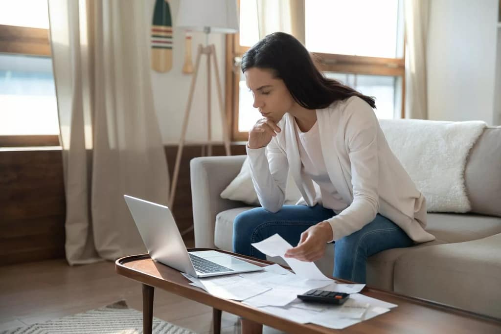 Woman looking at her computer while working o.width TmoSZ.jpg