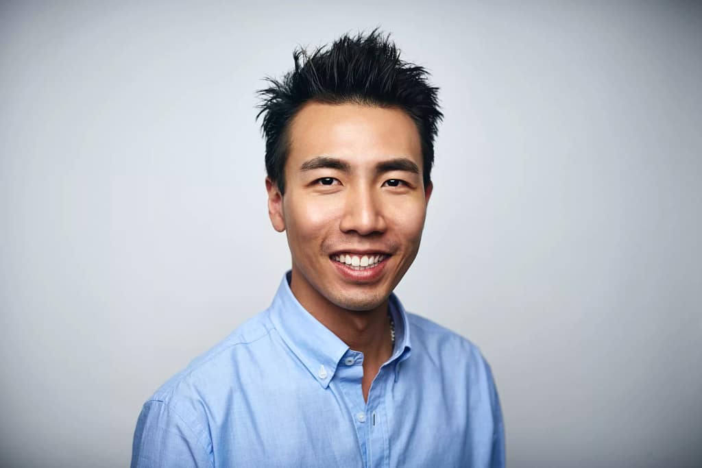 getty happy person in blue oxford shirt slight smiling.jpg