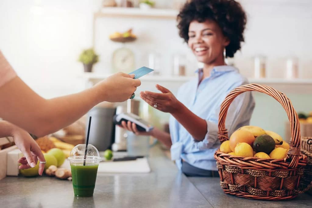 Cashier at cafe running credit card iqMfc.width .jpg