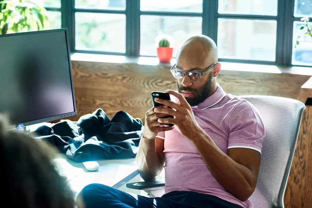 Man looking at phone contemplative QBnEzD.width .jpg
