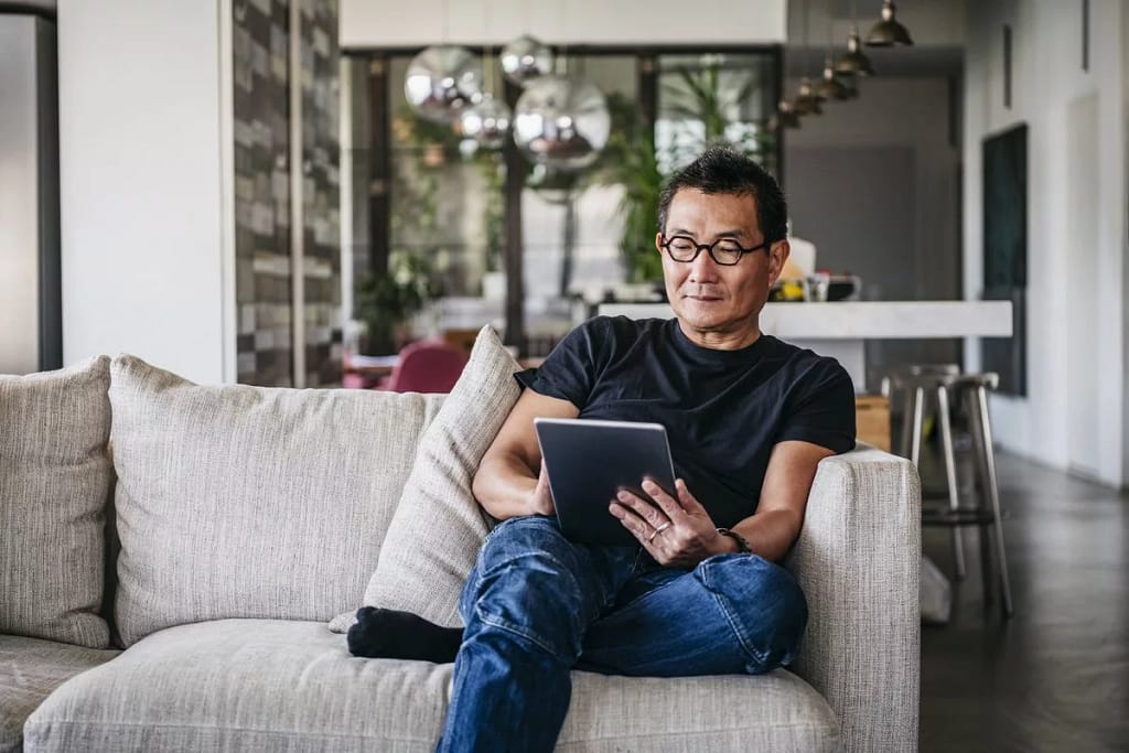 man on couch with tablet FFkBeEk.width .jpg