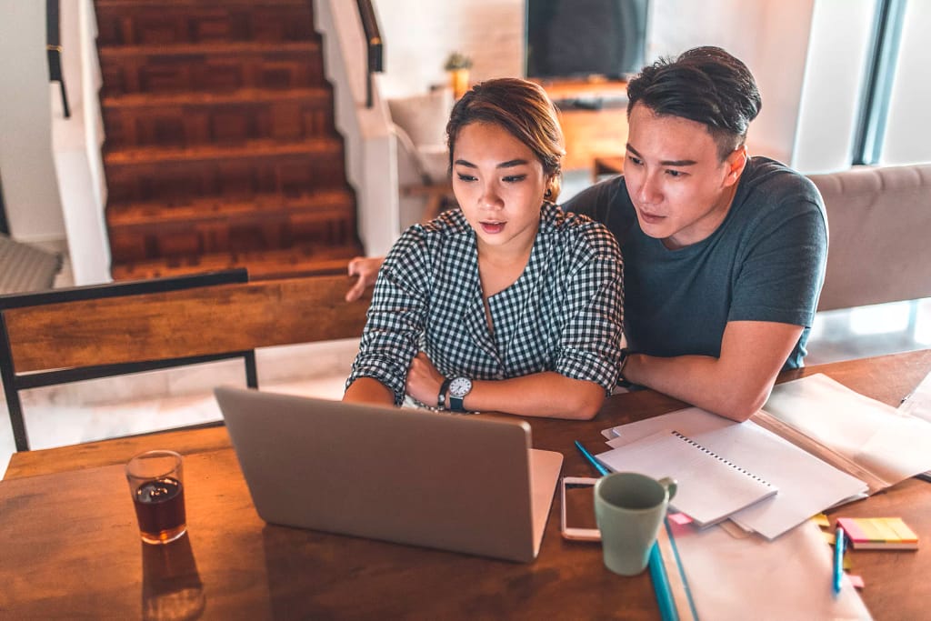 serious couple looking at laptop and discussing finances.jpg