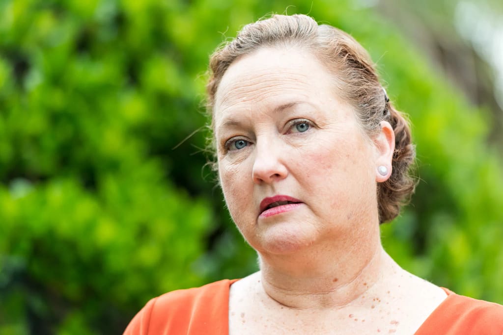 getty person looking concerned thoughtful worried green background.jpg