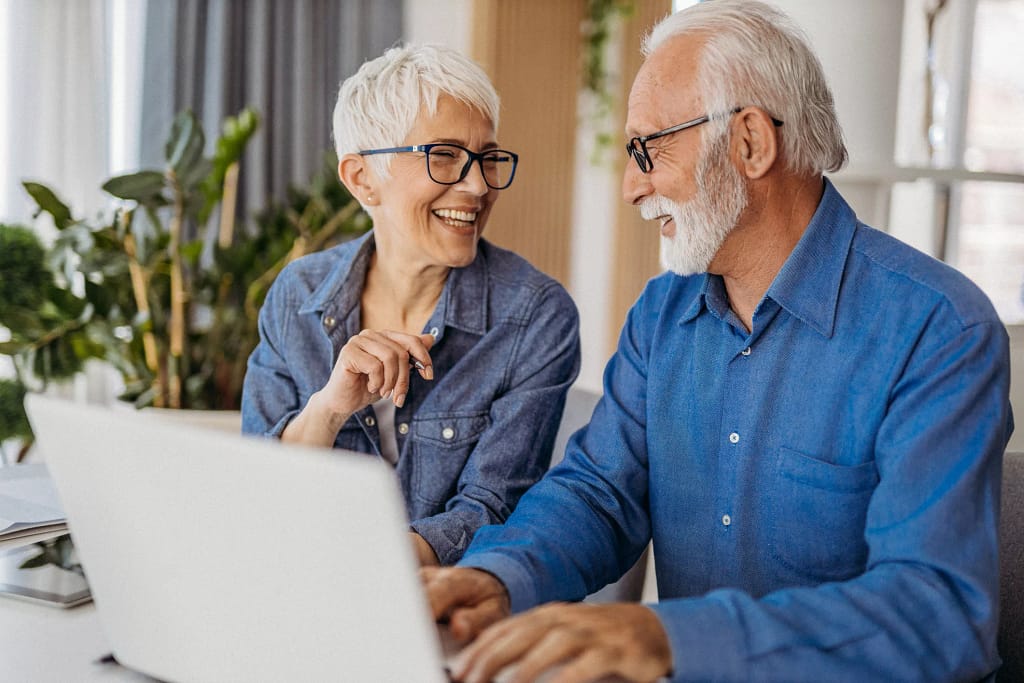 senior couple at laptop smiling gettyimages .jpg