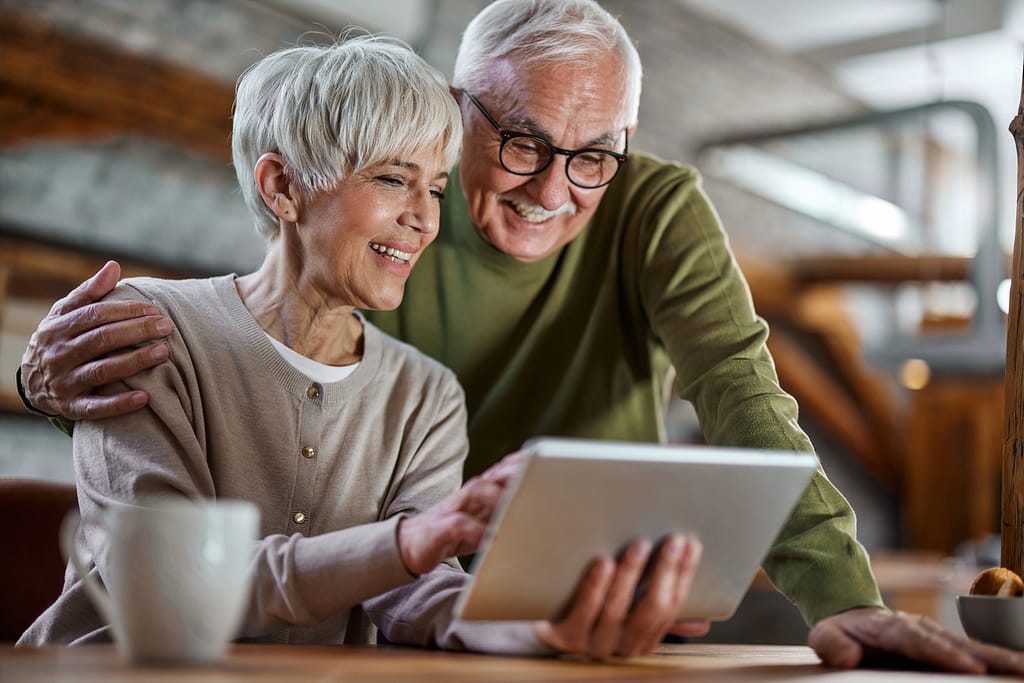 smiling couple looking at tablet together.jpg