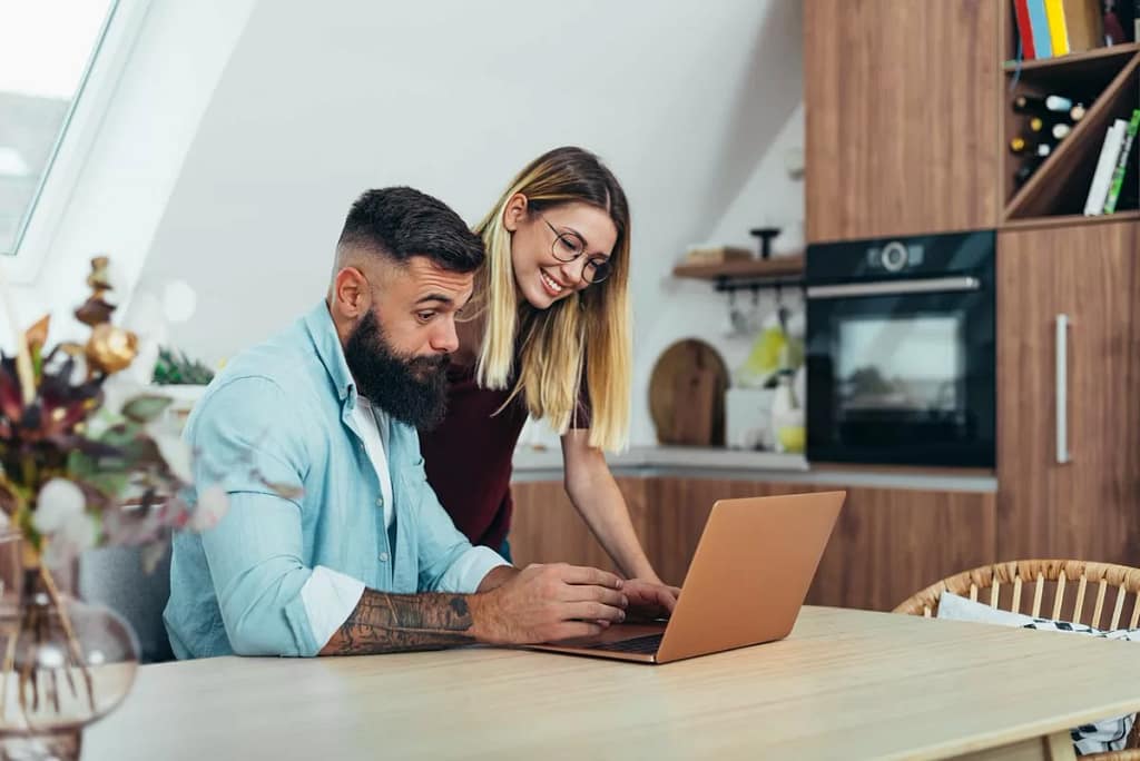 Couple looking up something together on lapto.width oTmPZpv.jpg