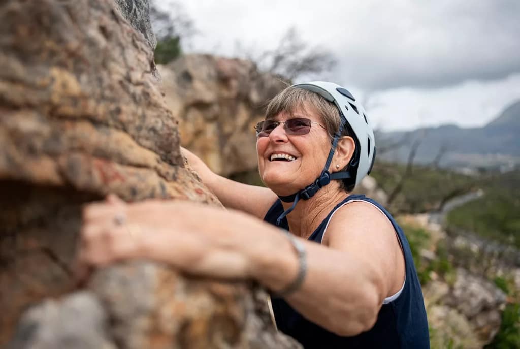 smiling person rock climbing.jpg