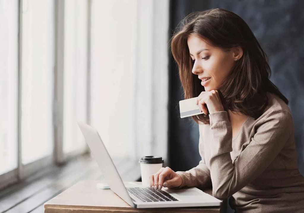 Woman on laptop with credit card BLbaw.width .jpg