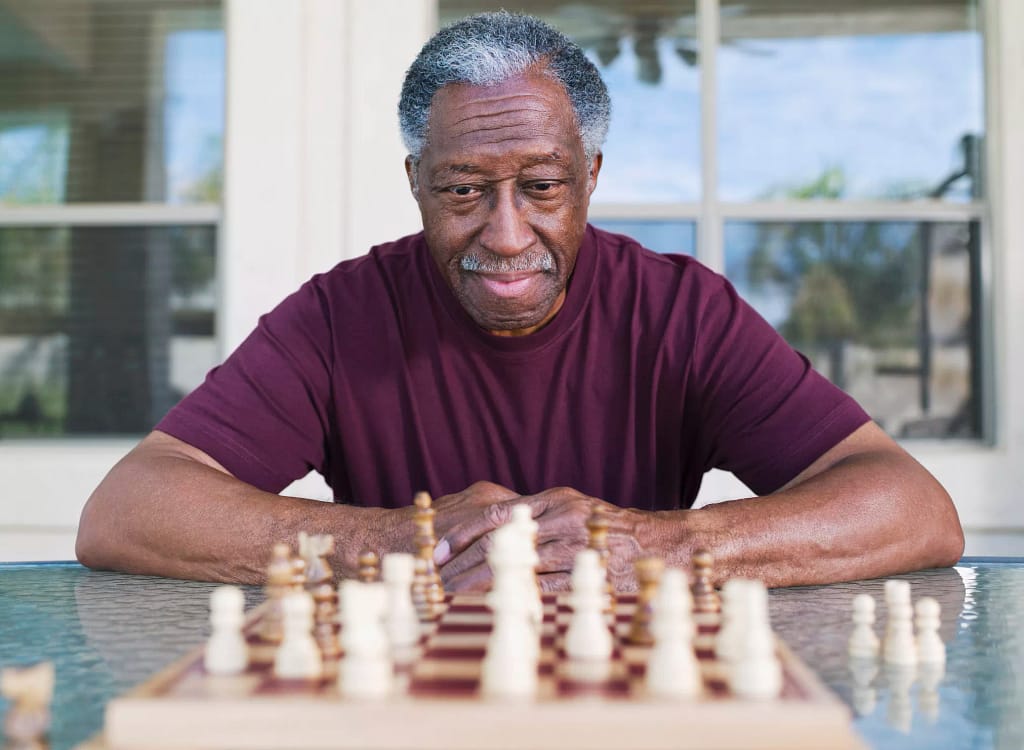 older man playing chess strategy moves winning.jpg