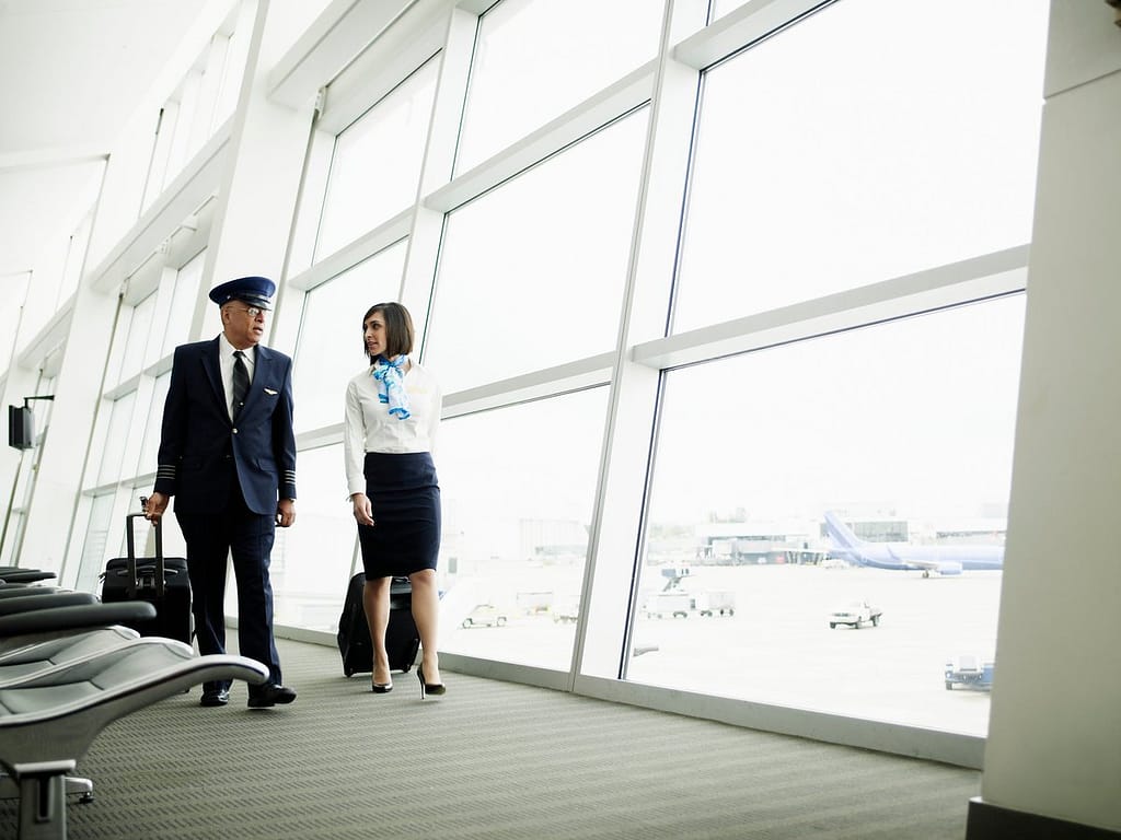 Pilot and flight attendant walking to airport.width LhaGV.jpg