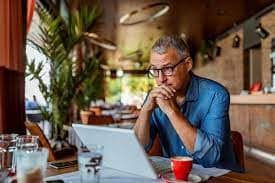 a person wearing glasses looking at laptop.jpg