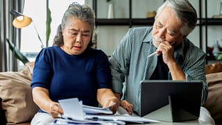 older asian couple stressed NntkJ