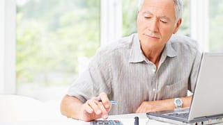 senior man using calculator gettyimages 107071080 KYLDaV