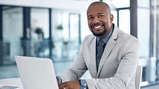 man s business suit laptop gettyimages xRtoVl