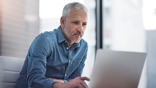 older man laptop a person at a laptop gettyimages PmKD