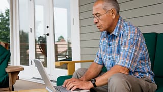 older man laptop outdoors gettyimages