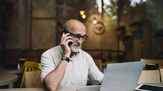older man laptop phone upset gettyimages DKKnZ