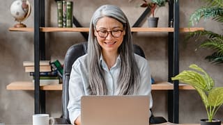 older woman laptop smiling gettyimages